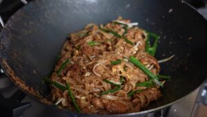 A Close-Up of A Wok Filled with Chicken Pad Thai