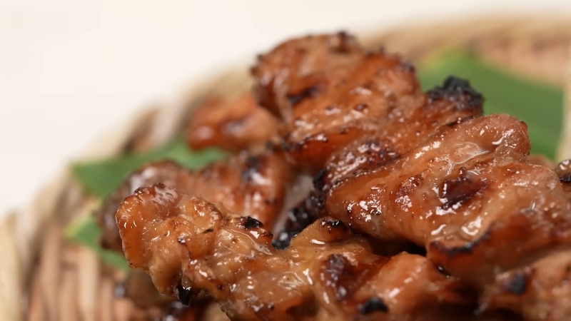 Close-up of juicy grilled Moo Ping skewers with caramelized edges